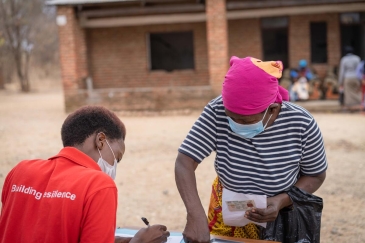 Khadija receiving the payout at the distribution center