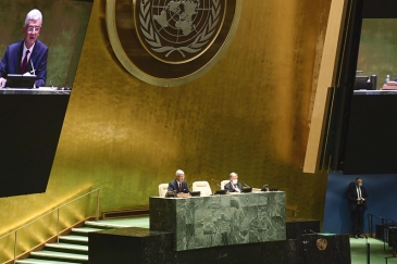 Volkan Bozkir (left at dais and on screens), President of the 75th session of the United Nations Gen