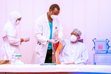 Nigerian President Muhammadu Buhari receives a dose of COVID-19 vaccine in Abuja, Nigeria.