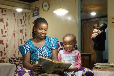 Solar home systems benefits a family in rural communities of Rwanda.