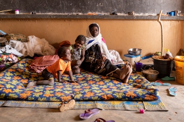 A displaced family from a village in Mali was relocated to a former school.