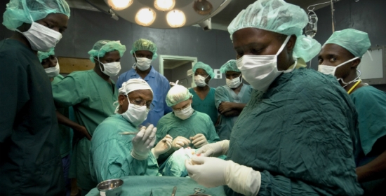 Medical students watch as doctors perform an operation in Moshi, Tanzania. Photo credit: Panos/ Sven Torfinn