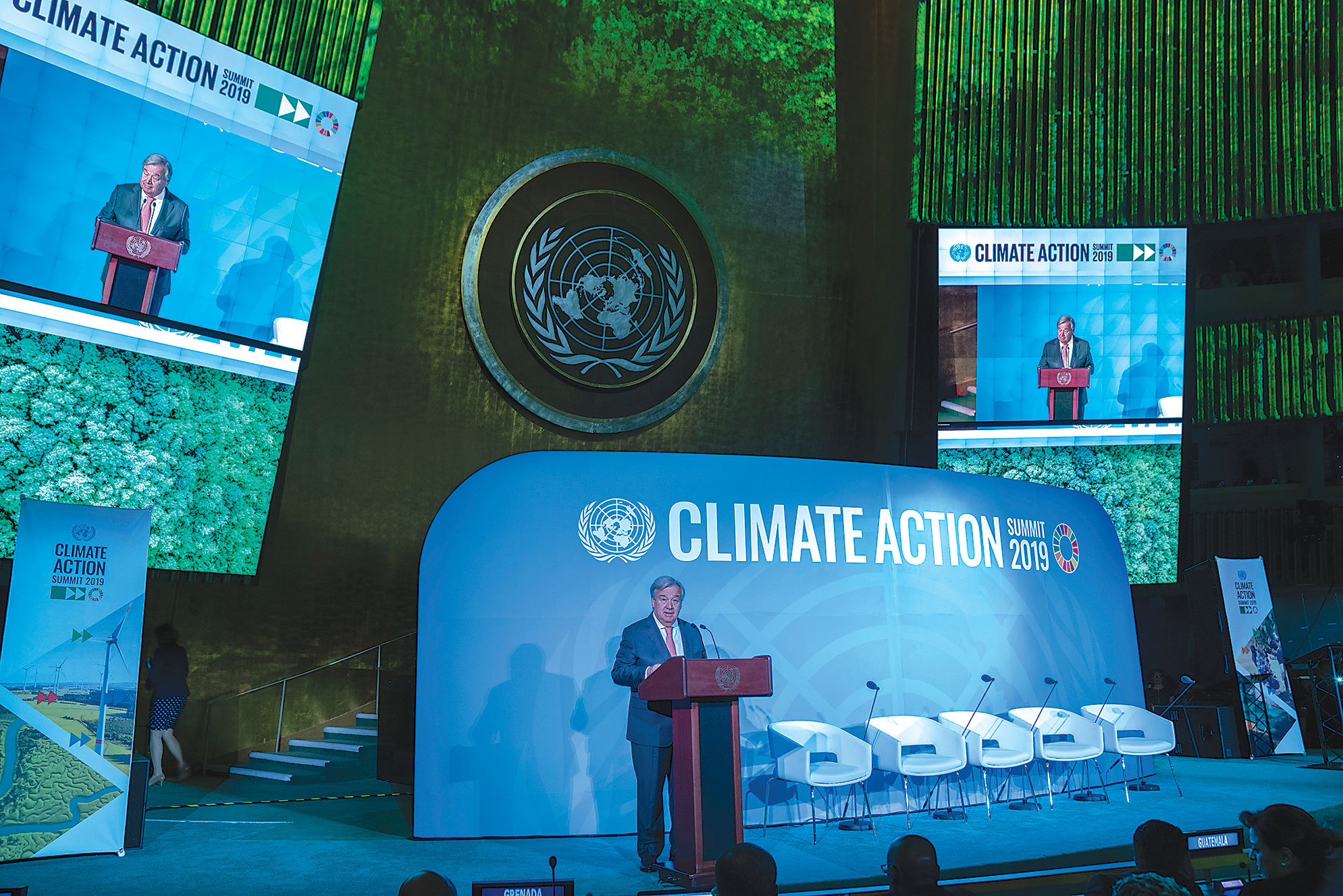 Secretary-General António Guterres standing in front of lectern on podium.