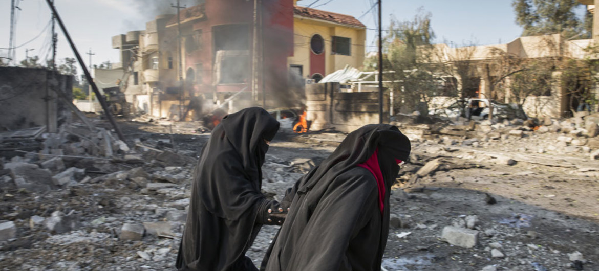 Family climbs out destroyed home after an ISIL bomb