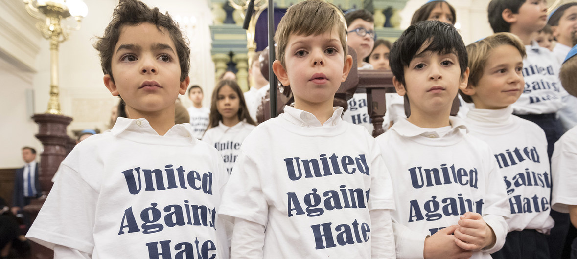 Children wearing United Against Hate t-shirts