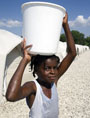 Haitian girl gathers water (UN Photo/Sophia Paris)