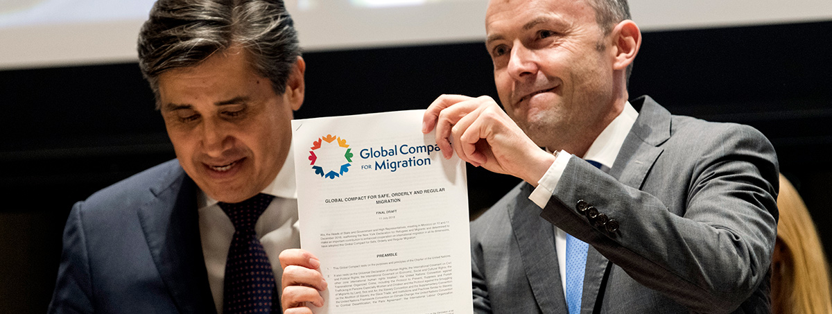 Juan José Gómez Camacho (left), Permanent Representative of Mexico to the UN, and Jürg Lauber, Permanent Representative of Switzerland to the UN, Co-facilitators for the Global Compact on Migration process, hold up the final draft of the document.