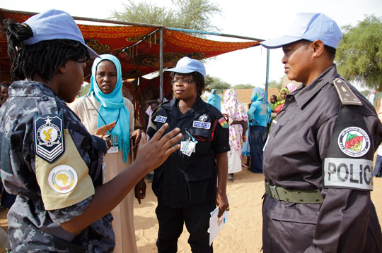 Police officers serving with the United Nations-African Union Mission in Darfur patrol the Zam Zam camp in El Fasher, Sudan, 2010.  UN Photo/Olivier Chassot