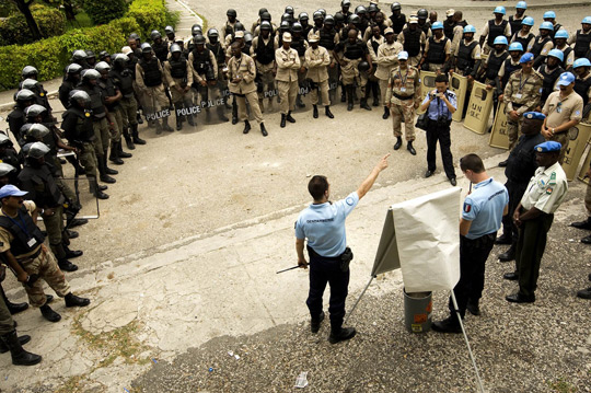 United Nations police officers from France and a Formed Police Unit from Pakistan prepare to conduct a crowd control exercise with members of the Haitian National Police, 2008.  UN Photo/ Marco Dormino 