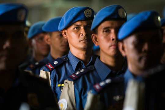 Filipino police officers serving in Darfur stand in formation waiting to be awarded the UN peacekeeping medal near the completion of their duty in Sudan, 2010. UN Photo/ Albert Gonzalez