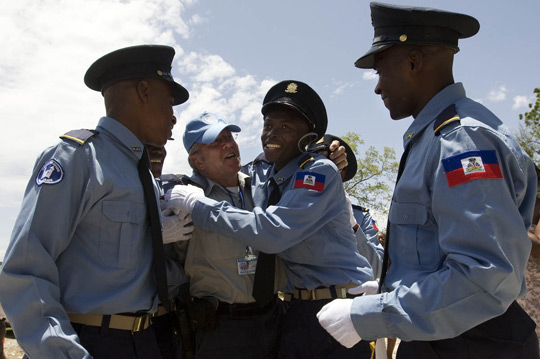 Exuberant graduates from the Haitian Police Academy show their appreciation for one of their UN Police instructors,  2009. UN Photo/ Marco Dormino