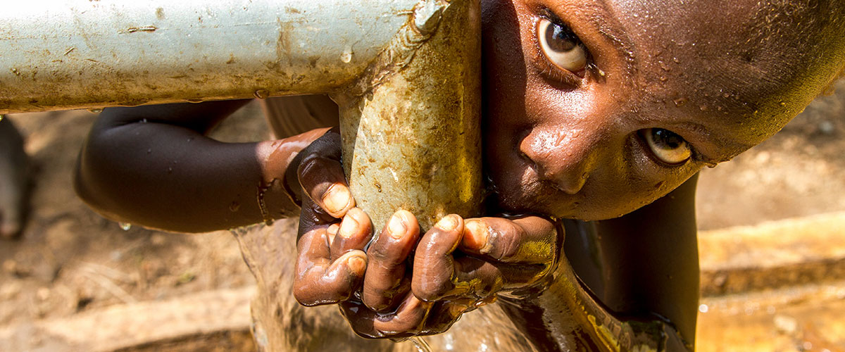 Marakera, an Ethiopian 5-year-old boy, drinks clean piped water.