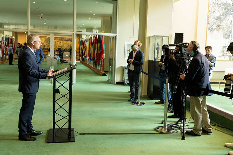 Csaba Kőrösi at podium briefing reporters outside the General Assembly Hall.