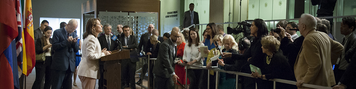 Ségolène Royal (at lectern), Minister of the Environment, Energy and Marine Affairs of France, responsible for International Climate Relations, and President of COP21, speaks to journalists following her meeting with Secretary-General Ban Ki-moon. UN Photo/Loey Felipe