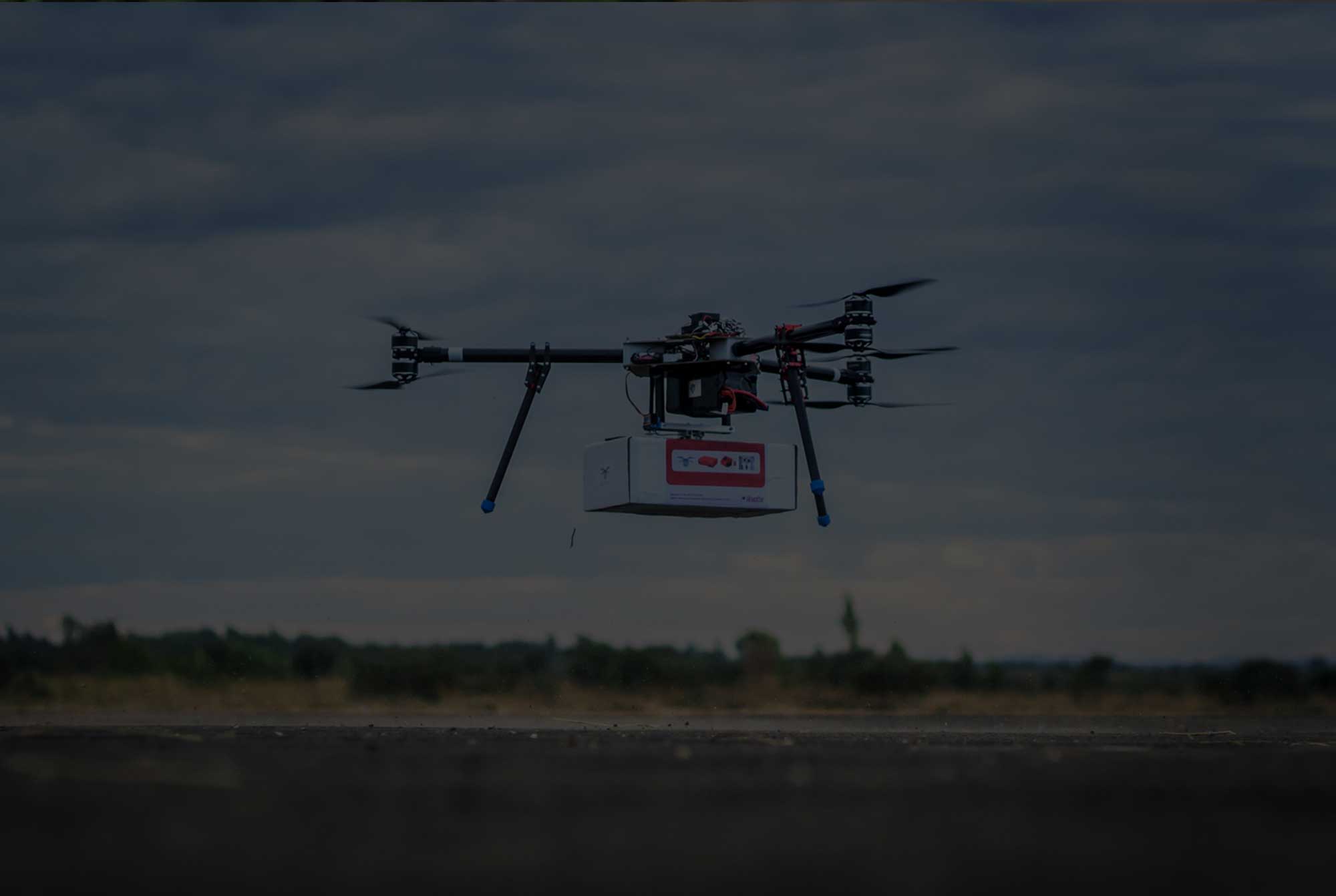 The UNICEF Innovation team tests an unmanned aerial vehicle (UAVs), also known as a drone, carrying a cargo payload box, which can potentially carry humanitarian supplies at Kasungu Aerodrome in central Malawi. Photo: UNICEF/Chisiza