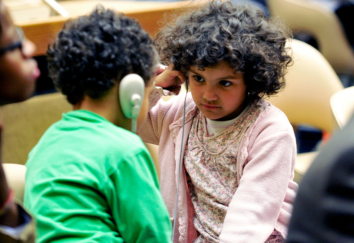 Two children attend a ceremony in observance of the fifteenth anniversary.