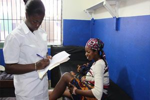 A mother and her newborn are shown sitting in the waiting room of a medical centre.