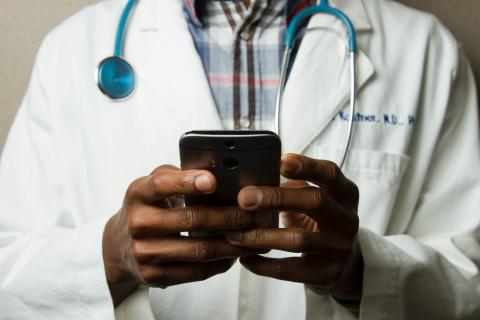 Doctor presumably providing medical advice on their cellphone