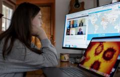 Person trying to navigate information material on different computer screens