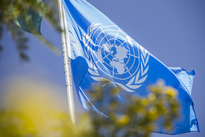 A close-up of a blue UN flag
