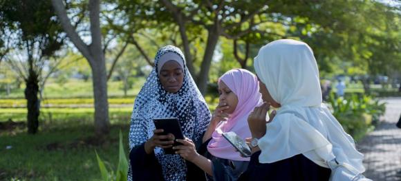  Students from the State University of Zanzibar, in Tanzania use tablets to collect data to help mapping new locations of solid waste pick up sites.