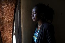 A young woman in the Democratic Republic of Congo looks out the window