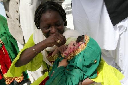 Une jeune mère sourit en nourrissant son enfant