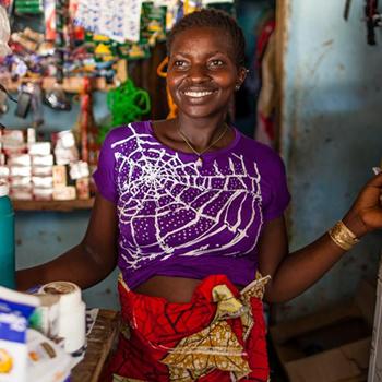 Woman smiling while working on her store