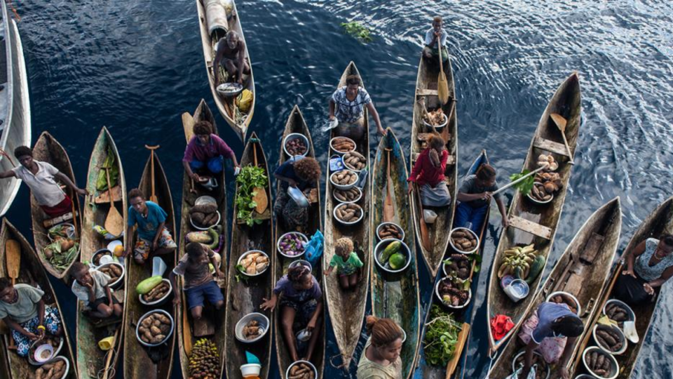 Floating local market on artisanal canoes