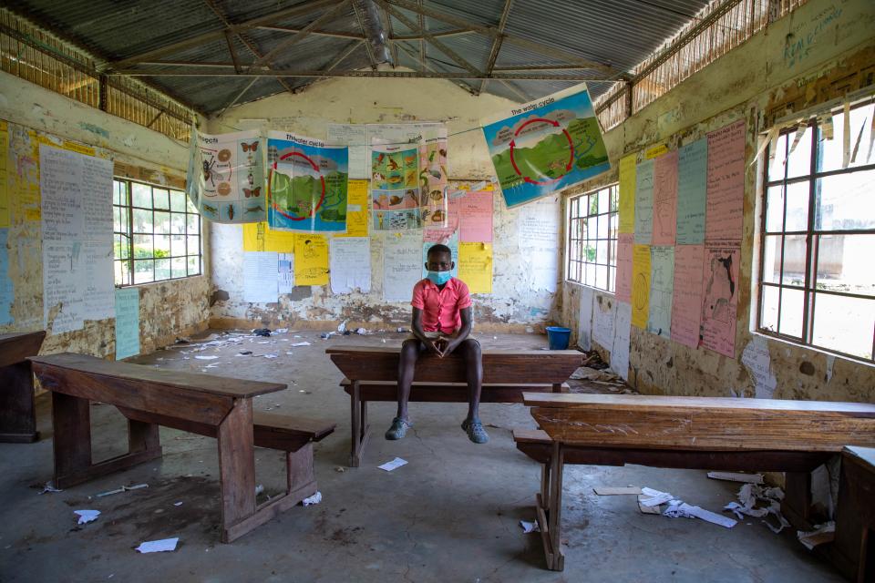 Patrick Lotukei sitting in an empty classroom as schools in Uganda remained closed due to the COVID-19 pandemic. Education is one of the many priorities for LDCs as they seek to rebuild from the pandemic.