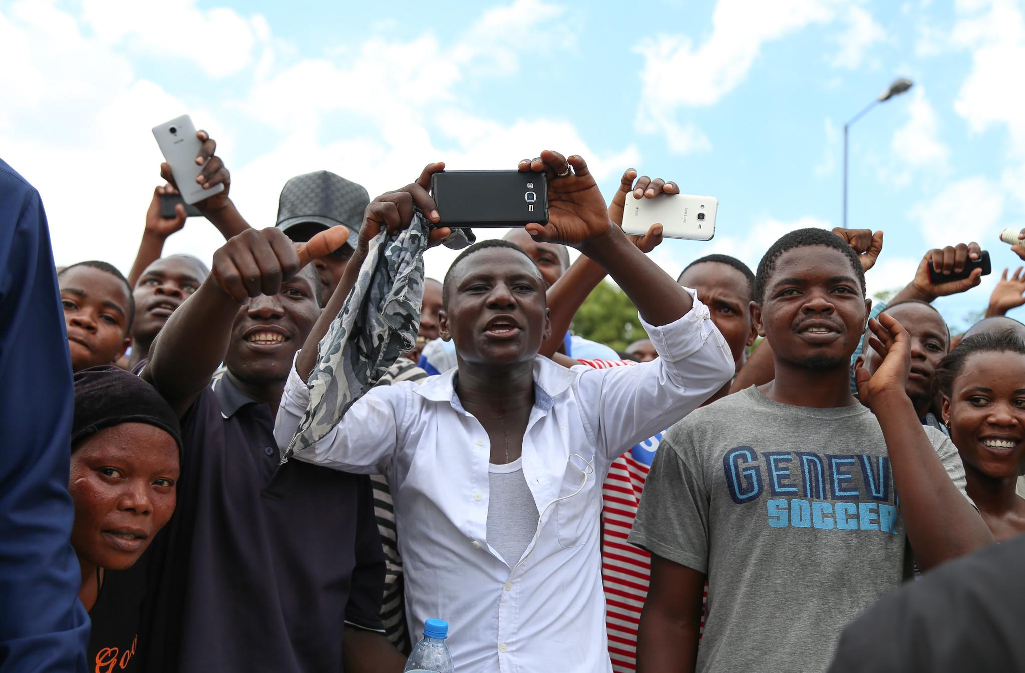 Audience members in Dar es Salaam cheer during a speech by President John Magufuli of Tanzania