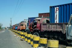 Trucks with cargo containers wait to enter Aden Port