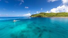 Small boat on the crystal clear waters