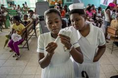 Haitian patients arrive for regular check-ups and vaccinations. Due to COVID-19 they now might