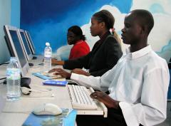 Young communities use computers in an internet cafe in Kampala, Uganda.
