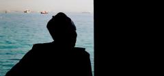 Photo of a visitor looking through the door of no return at Goree Island