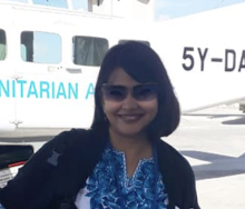 A lady standing infront of an aircraft