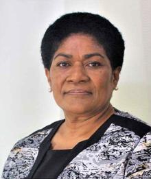 A close up photo of a lady with short hair