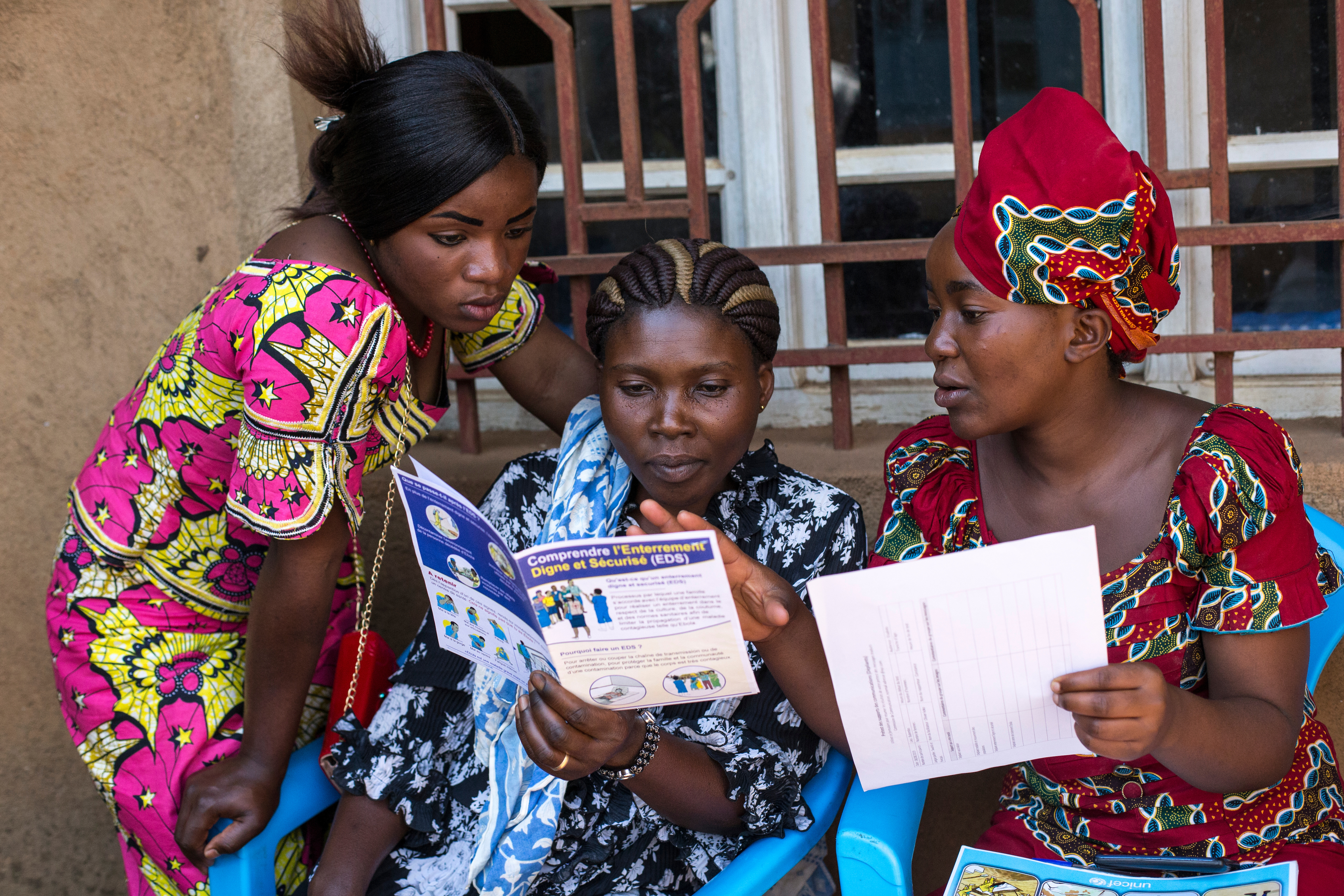 women with Ebola education leaflets