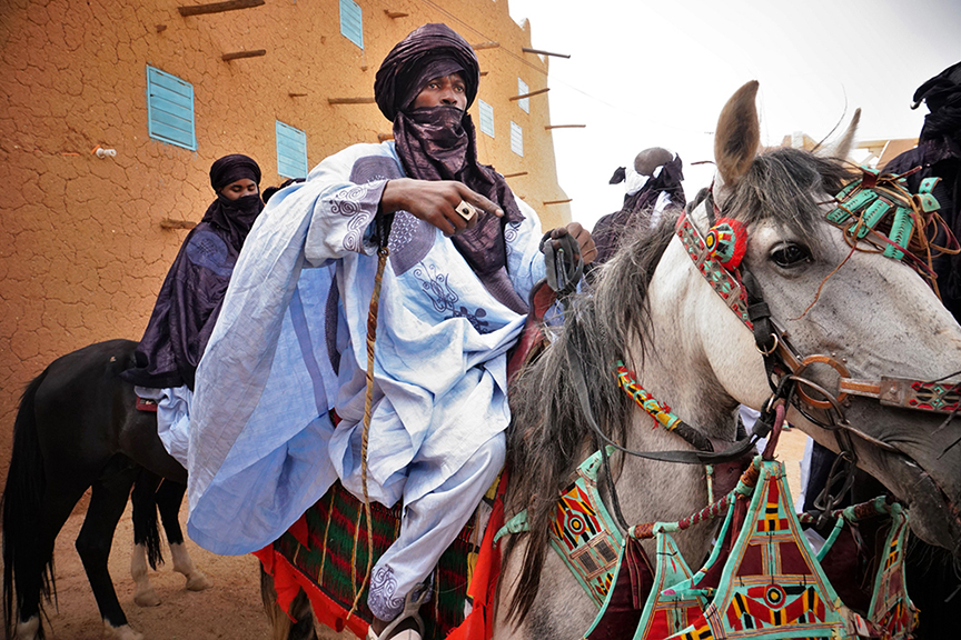 Men riding horses in Agadez.