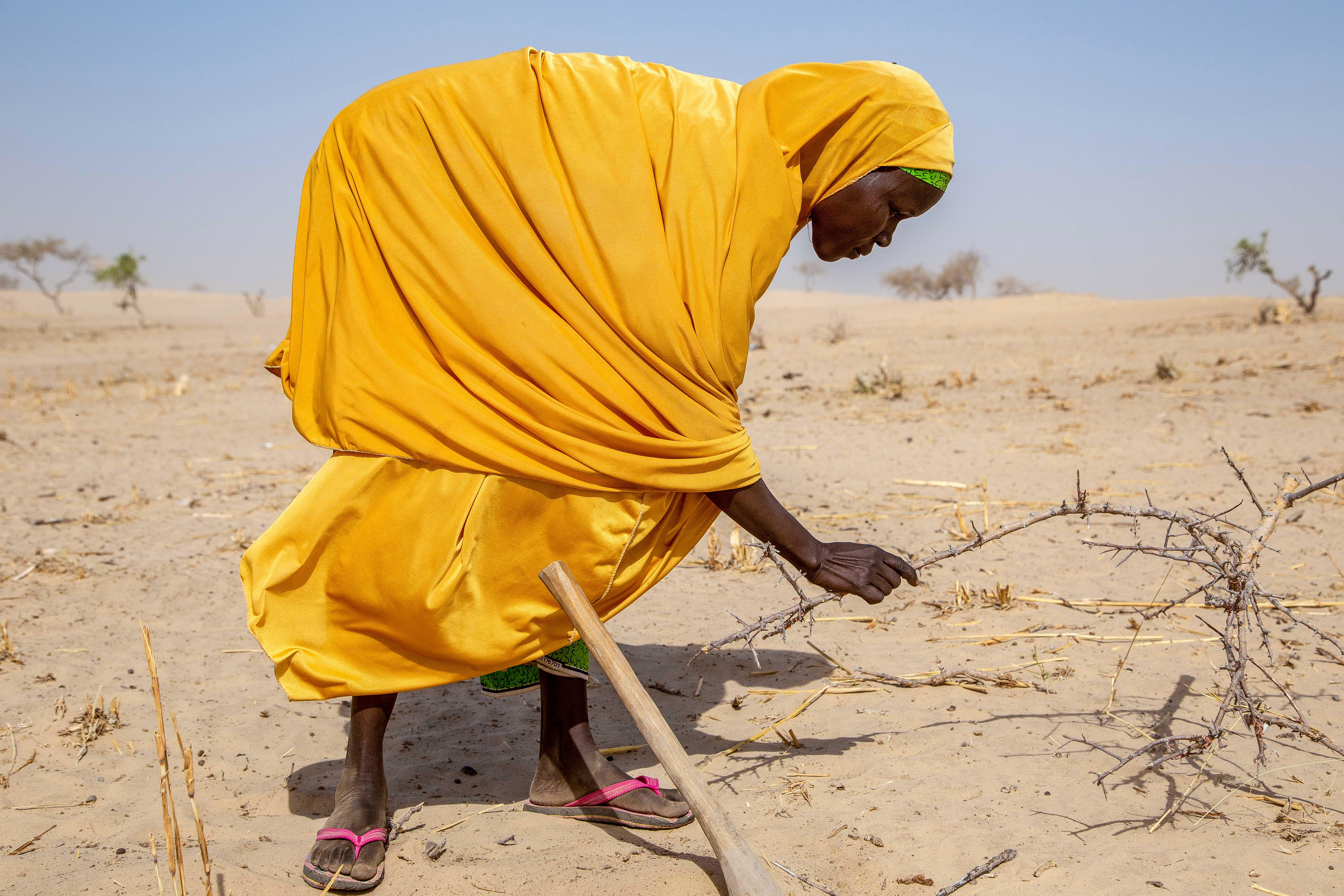 woman working on land during drought