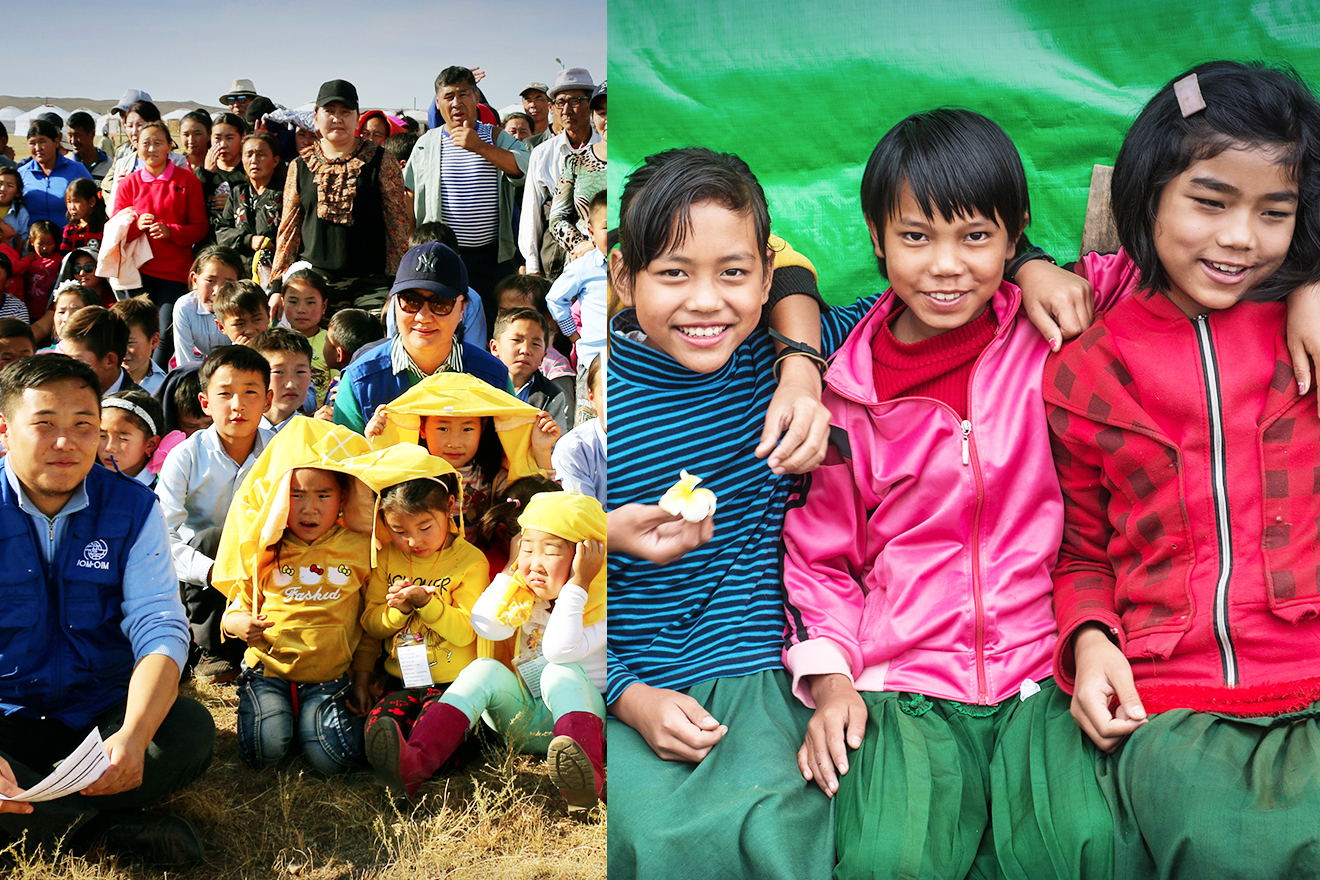 Children and adults gathered in an open field for a photograph with IOM staff.