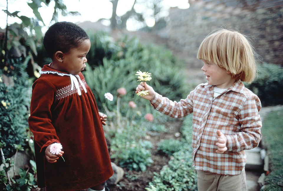 boy offering flower to girl