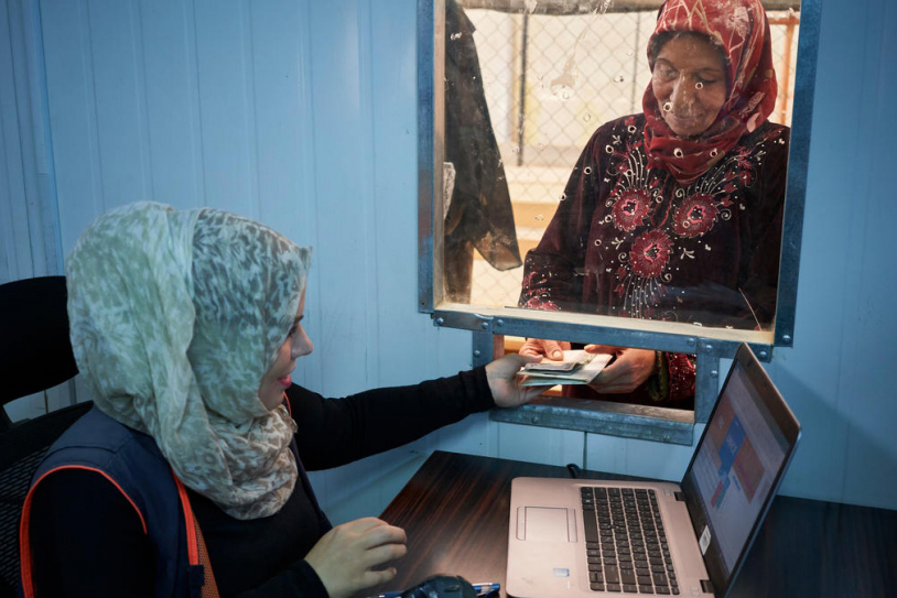 Syrian refugees queue for winter cash assistance at Zaatari refugee camp in Jordan