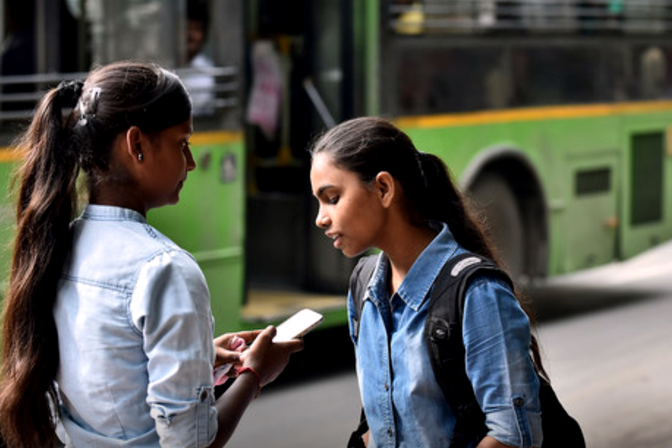 two girls looking at cell phone