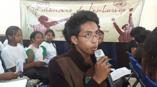 A student poses a question at the commemorative ceremony organized by UNIC Antananarivo