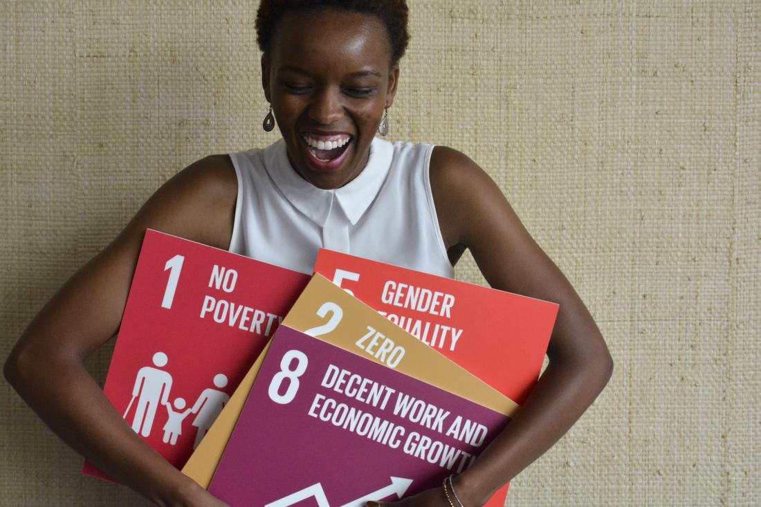 Young woman holding SDGs signs