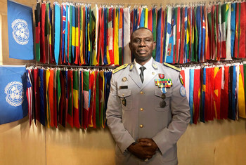 Portrait photo of Lieutenant General Balla Keïta of Senegal, outgoing Force Commander at MINUSCA, with flags of UN member states behind him.