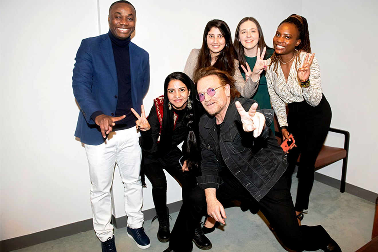 Singer and co-founder of the ONE campaign, Bono, poses for a photo with youth leaders and activists.