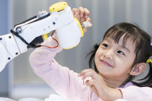 girl playing with robotic arm